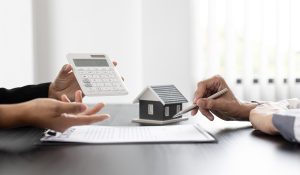 Two people debating and calculating home insurance