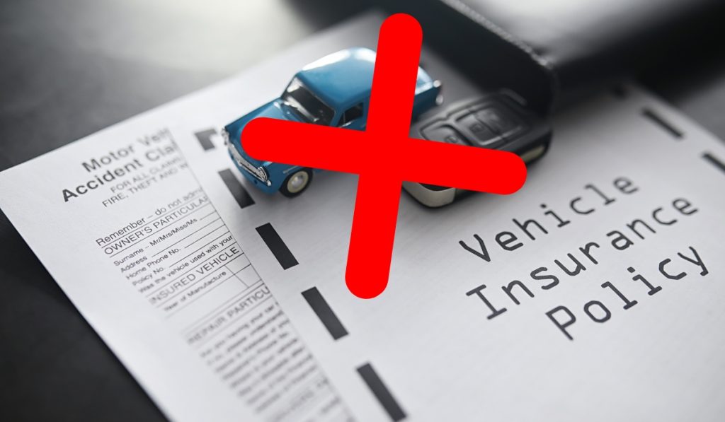 toy car on a "vehicle insurance policy" crossed out