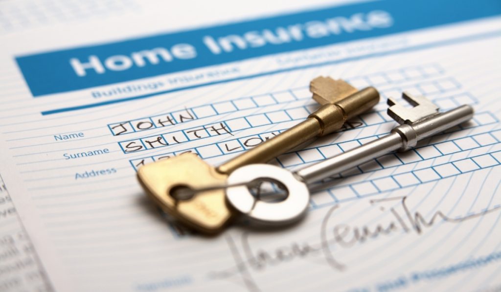 Keys on top of a home insurance agreement
